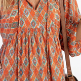 Cornia | Geometric Print V Neck Tiered Midi Dress